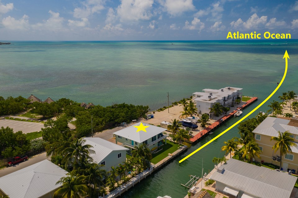 instant atlantic ocean access from your backyard. multi-family home with all units currently occupied and generating a substantial income. this property is a solid investment featuring a concrete build, metal roof, impact-resistant windows and doors. this well-maintained property features lush green landscaping and a freshly painted exterior. the 1 bedroom, 1 bath unit offers a full kitchen, recently painted beach house colors, and updated modern bathroom design. the 2 bedroom, 2 bathroom unit features a master suite, fully-equipped kitchen, and ocean views from your windows and balcony. the downstairs bonus room charms with terrazzo flooring. the fisherman's dream backyard boasts 60 feet of water frontage located just minutes from instant access to the atlantic, a prime location in the florida keys!